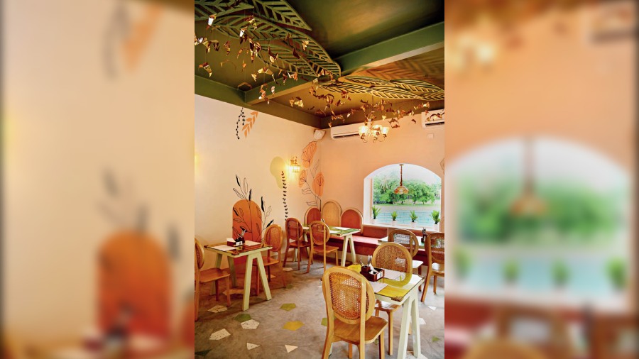 Done in shades of peaches and pinks with muted moss green, this section has windows running all around and lets in plenty of sunlight as well as a spectacular view of the greenery outside. The walls too have floral patterns drawn by hand. Soft lighting and pampas grass chandelier lines the ceiling, lending it a very European vibe.