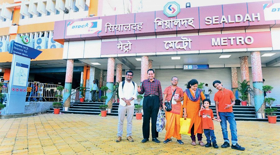 Rajib Roy of AC Block (third from left) with family and other early passengers in front of the Sealdah Metro station. 