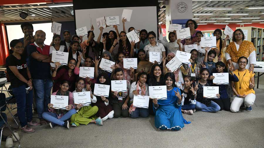 Girls wave their certificates after attending a workshop encouraging girls to pursue a career in Science at American Center on Friday. Organised by the U.S. consulate general Kolkata, the workshop’s motto was “Nurturing Young Women in STEM” (Science, Technology, Engineering and Mathematics).
