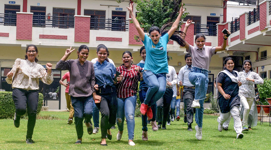 Students celebrate after the declaration of CBSE Class XII exam results in Prayagraj on Friday.