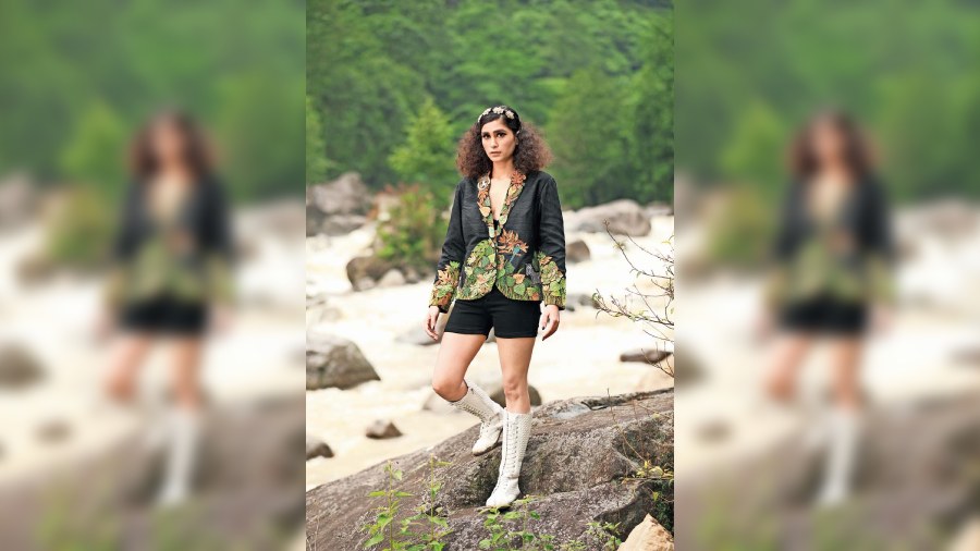 The 3D embroidered raw silk jacket captures the jungle scene and is a versatile piece that can be paired with shorts, sari or a bralette.