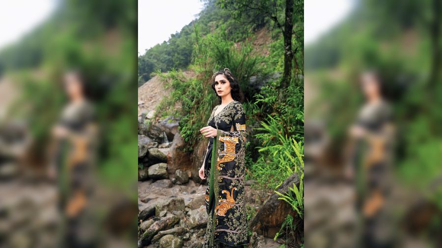 One of the first pieces of the collection and a tribute to the ‘collarwali’, the hand-embroidered sari is designed with the regal Royal Bengal Tiger motif. Made of Chinese dupion silk, the trees are embroidered with a 3D effect to add the jungle feel. The blouse has been specially designed with a net patch as a style element.