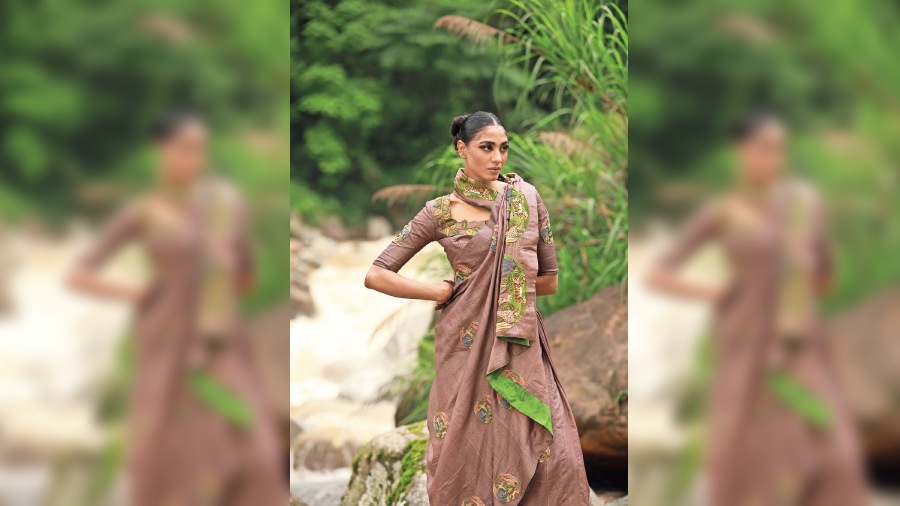 Based on the dark hues and earthy colour palette of the jungle, this brown handwoven tussore is designed with circles portraying the different animals that inhabit the jungle.