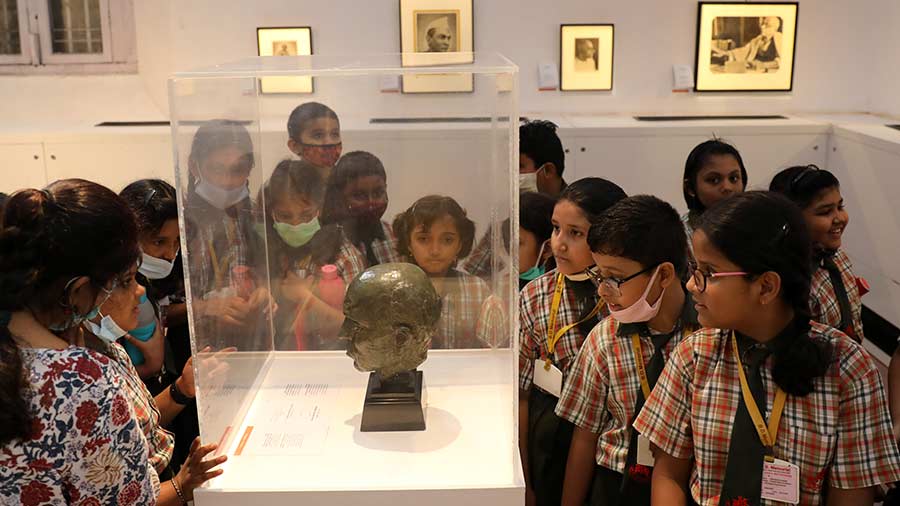 Students watch a historical artefact at the exhibition, which will stay open till September 18.