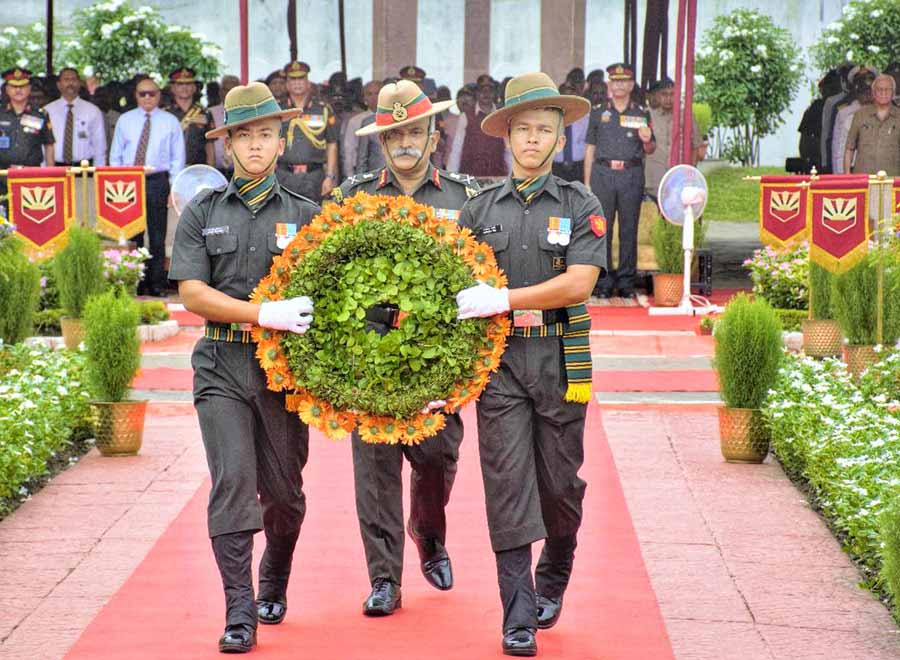 Lt Gen R.P. Kalita and two army personnel carry a wreath at the commemoration of Kargil Vijay Diwas at Fort William on Tuesday.