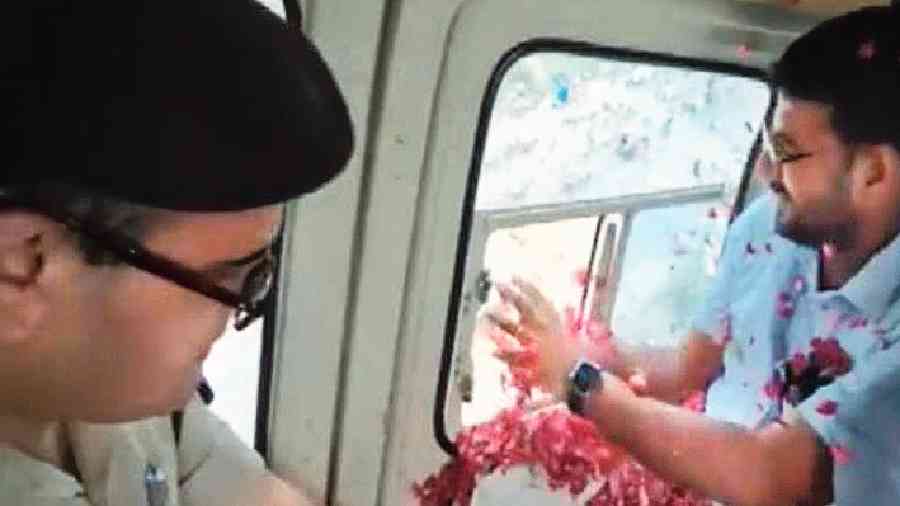 Footage shows the senior police officer and the district magistrate showering petals from a helicopter on the pilgrims