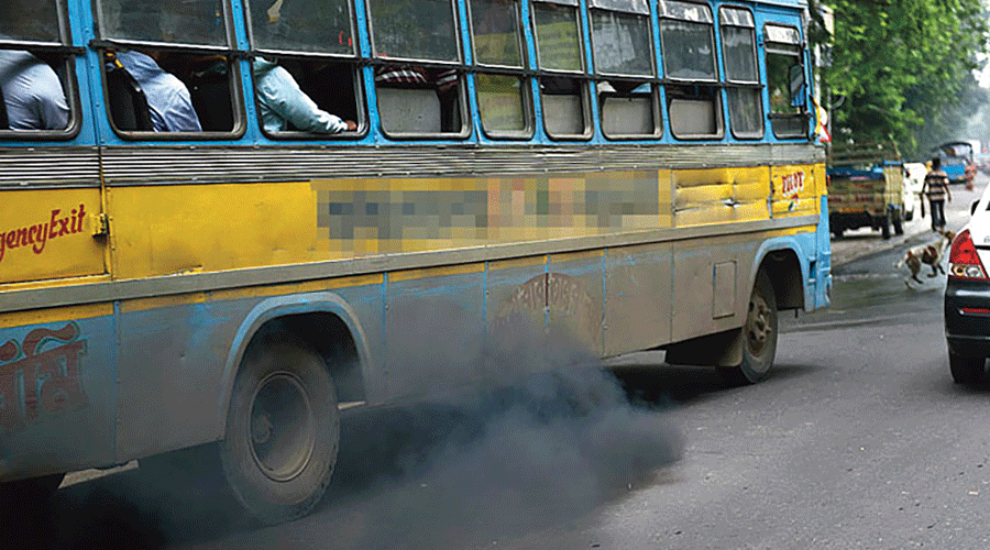 A smoke-belching bus in the city. 