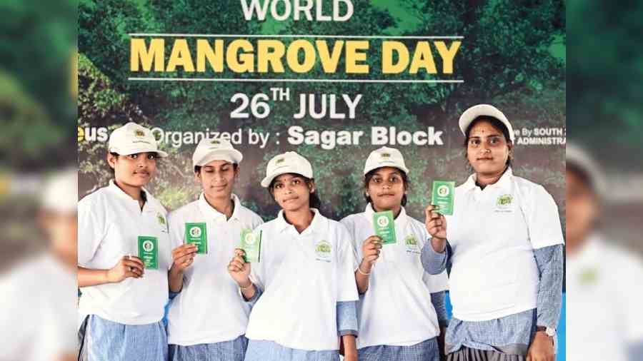 Kanyashree students with ‘Mangrove Yoddha’ identity cards at a programme in South 24-Parganas on Tuesday. 