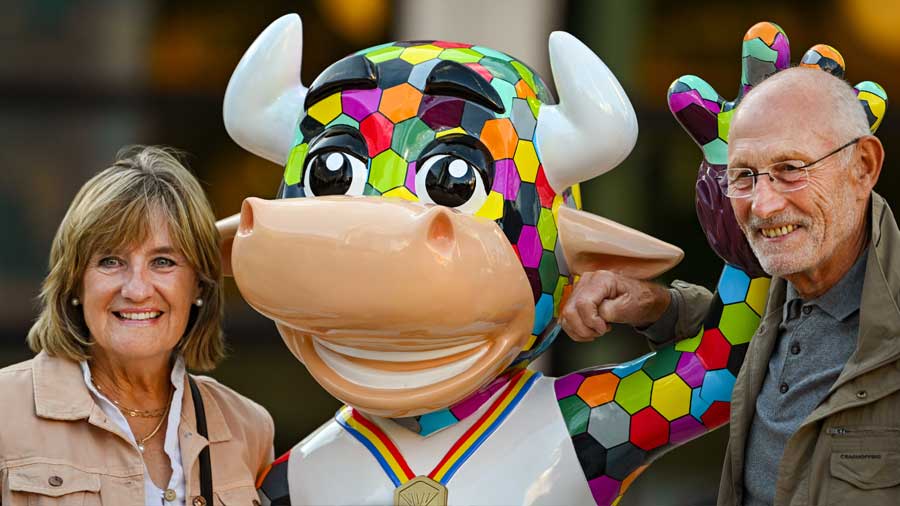 People pose for photos with Perry the Bull, the mascot of the game