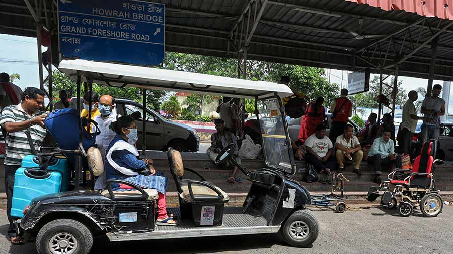 E-cart operator Surojit Patra collects passengers from the taxi stand.