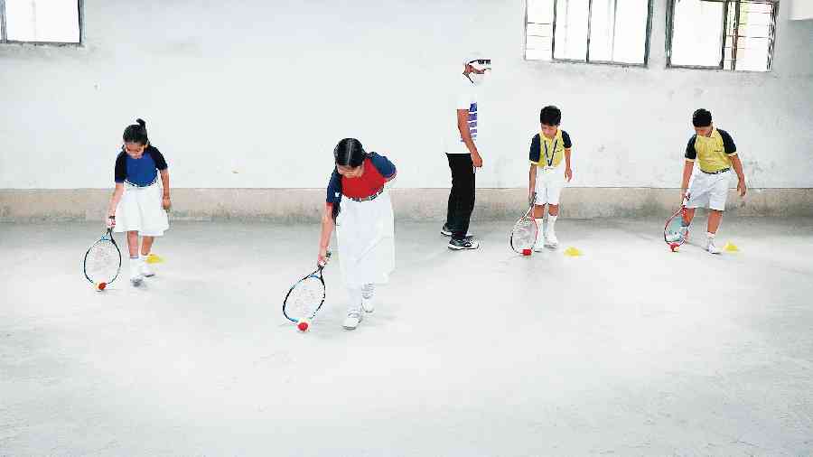 School students practice during the launch of the red ball mini tennis coaching programme at Central Public School in Jharkhand.  