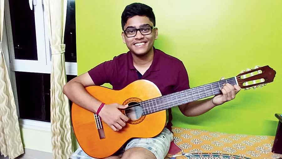 Aishwarik Dey strums the guitar at home in Elita Garden Vista, New Town.