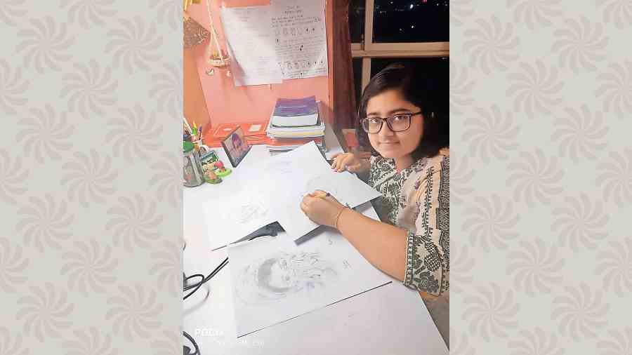 Aditri Gupta puts finishing touches to a sketch at her study table at Rosedale Garden, New Town.