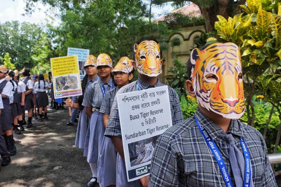 Schoolchildren with tiger masks in a rally brought out on the occasion of World Tiger Day at the Alipore zoo on Friday. The day is celebrated around the globe to raise awareness about the conservation and protection of tigers.