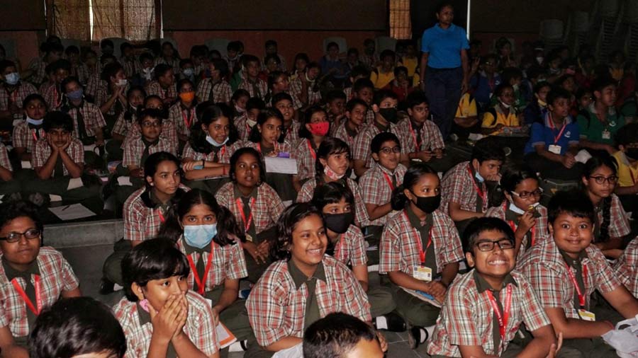 Students wait for the screening of a film at school.