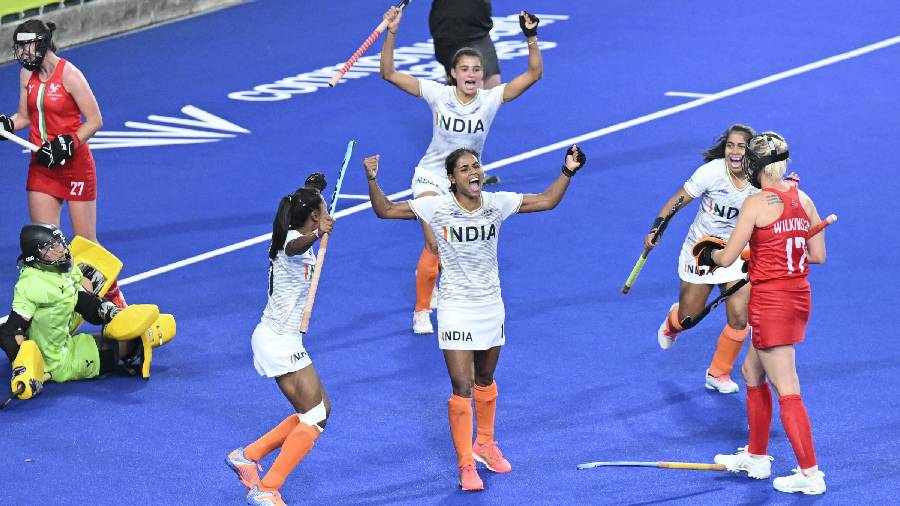 Indian hockey players celebrate after scoring a goal against Wales during the Pool A of women's field hockey match 