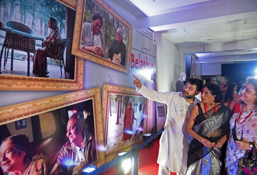 Director Shiboprosad Mukherjee shows veteran actress Sabitri Chatterjee and others still photographs from the film ‘Belashuru’ at an exhibition in Navina Cinema on Wednesday. The exhibition stays open till Thursday (from noo to 6pm)