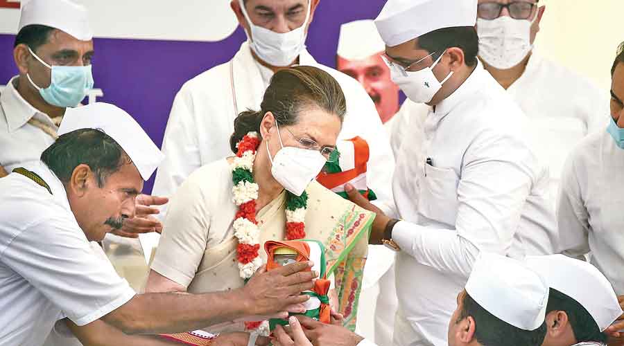 Sonia Gandhi receives sand and water of various states from “padyatris” at Rajghat in New Delhi on Wednesday as she participates in the party’s Azadi Gaurav Yatra.  