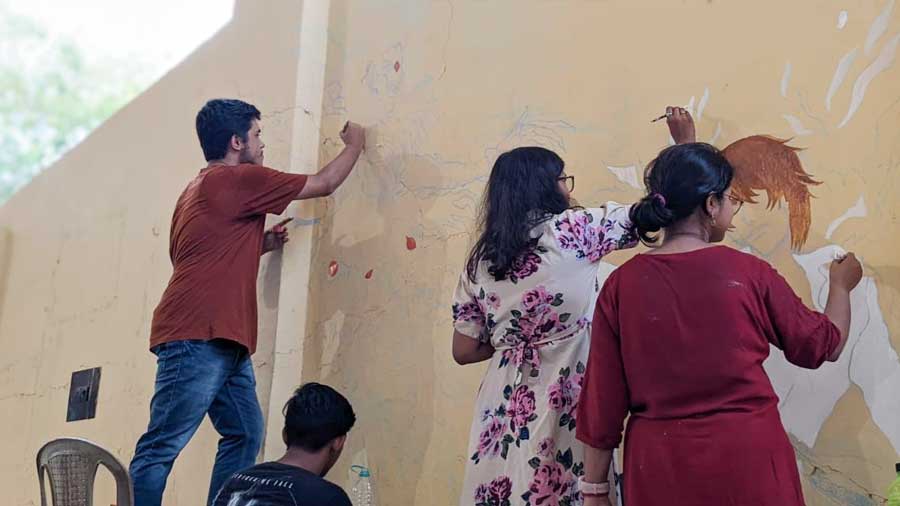 Jadavpur University students working on the graffiti