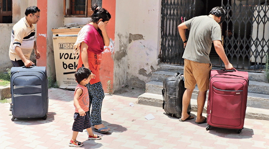 A Kashmiri Pandit family returns to the Jagti Migrants Camp in Jammu on Friday. 