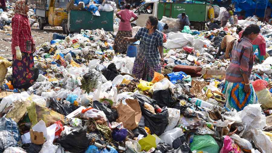 Ragpickers collect reusable items from a garbage dumping site in Hyderabad