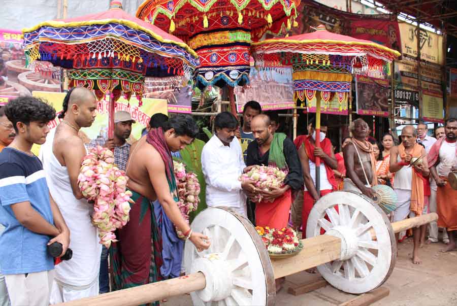 COUNTDOWN: Hindu priests worship the wheels of the chariot that will carry the deities Jagannath, Balaram and Subhadra on Rath Yatra at Rampurhat on Sunday, May 29. The Rath Yatra festival is on July 1.