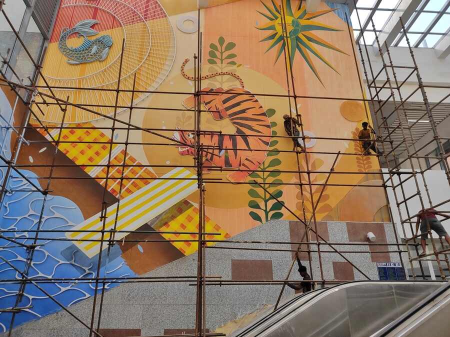 Workers lend finishing touches to a giant mural of a tiger at the Sealdah Metro station on Monday, May 30