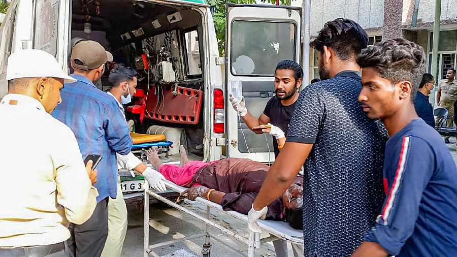  The injured being taken for treatment after at least twelve workers died when a boiler exploded at a chemical factory in Hapur district