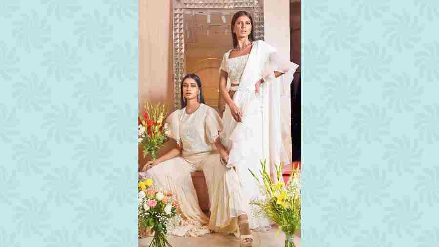 Meghna sported a summer easy-breezy look in an ivory short crop top detailed with ruffle sleeves and intricate tassel work, paired with georgette layered sharara. Ankita channelled a contemporary stylish look in the ivory sari set featuring 3D designs and beads. 