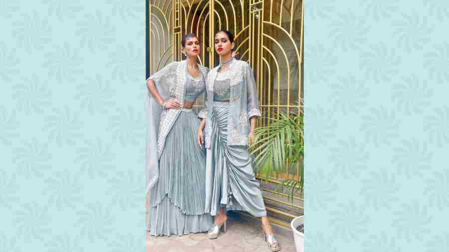Meghna Bose and Ankita Singh sported two occasionwear outfits perfect for making a style statement. Meghna in a gathered dhoti-style skirt made of satin, paired with a tassel-detailed silk bustier and embroidered organza cape. Ankita in a hand-embroidered layered lehenga, paired with a long cape. 