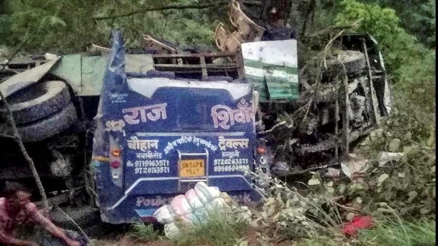 Wreckage of a bus after it fell into a deep gorge, in Uttarkashi district
