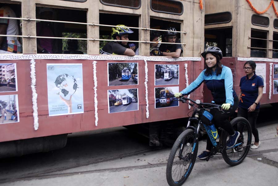 A bicycle and a tram amble along as part of the rally to mark World Environment Day on Sunday.