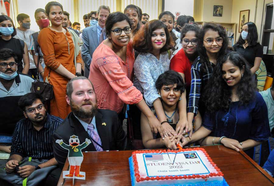 Students accepted by US colleges and universities for higher studies cut a cake to celebrate Student Visa Day at American Center on Tuesday.