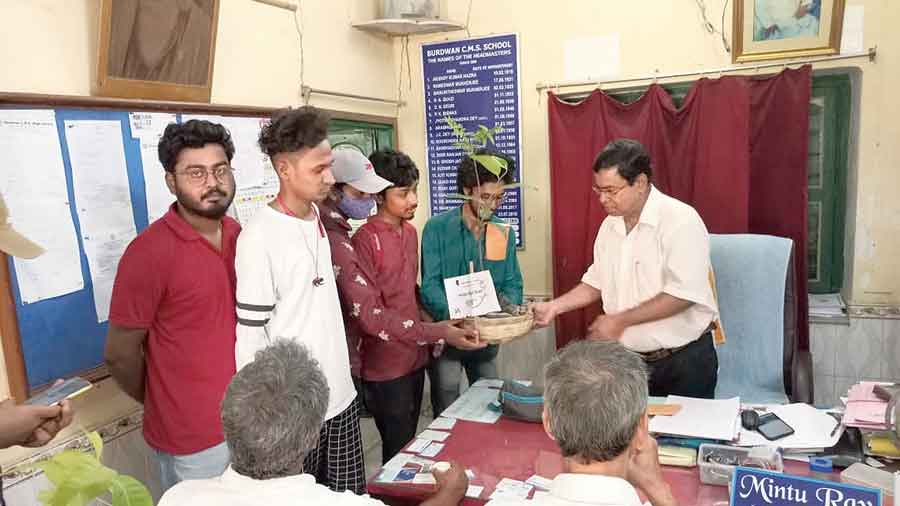 SFI activists distribute saplings in Burdwan on Monday. 