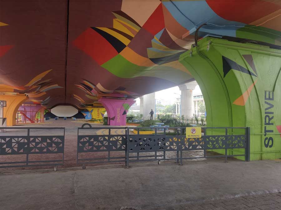 The underside of the flyover and its symmetrical pillars are painted in striking pop colours — pinks, yellow, oranges and blues — and carry words like ‘strive’, ‘share’, ‘learn’ and ‘zeal’