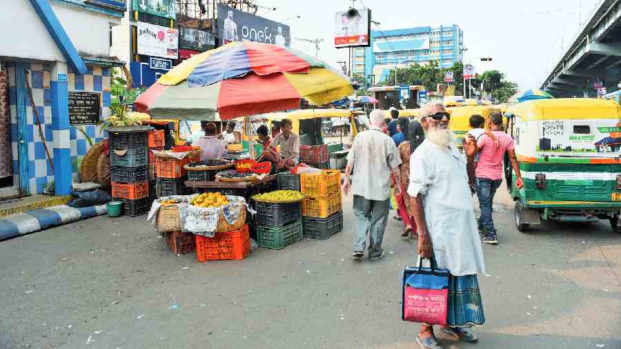 Parked autos and a fruit stall create a bottleneck on VIP Road near the Baguiati bus stop on Wednesday. 