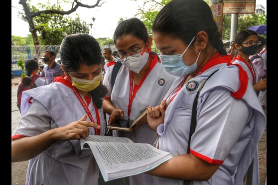 Students busy with last-minute preparations on the first day of the West Bengal Higher Secondary Examination 2022 at Bethune Collegiate School, Kolkata. 