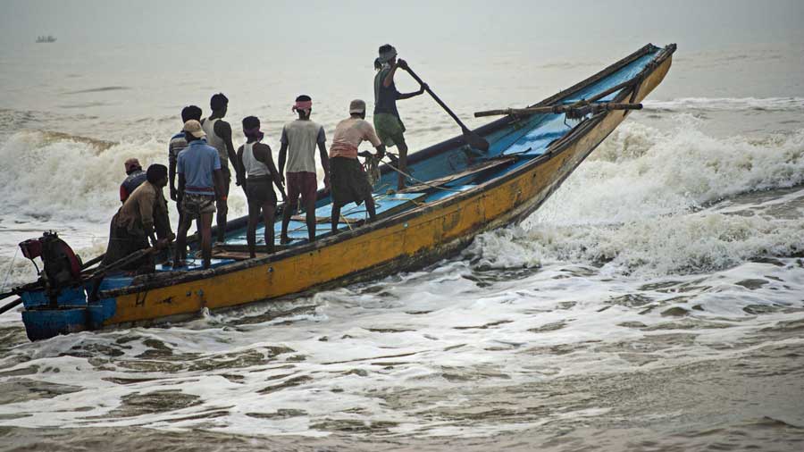 Fishermen venturing into the sea at Gopalpur