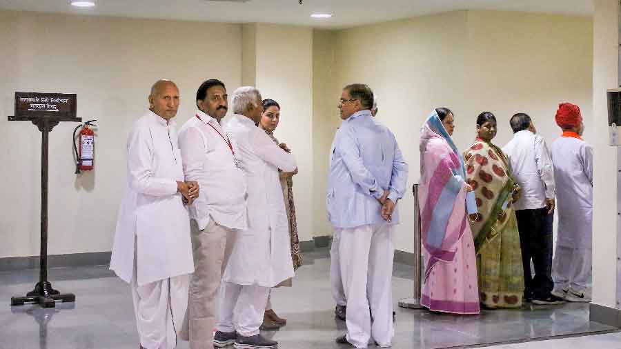 Congress and BJP MLAs wait in a queue to cast their votes during the Rajya Sabha elections, at Rajasthan Assembly in Jaipur