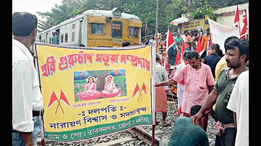 Members of the Matua community block the tracks near Taraknagar station on Friday morning.