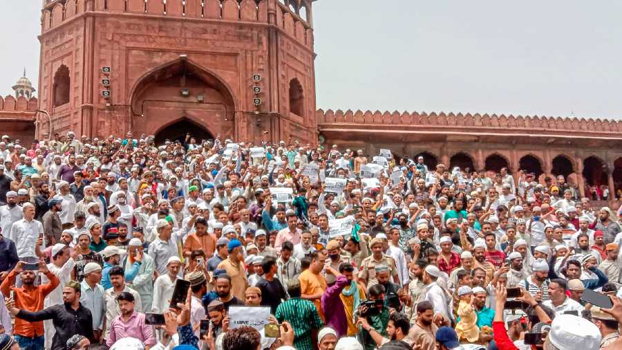 People belonging to Muslim community, holding placards, stage a protest after the Friday prayers at Jama Masjid, in New Delhi