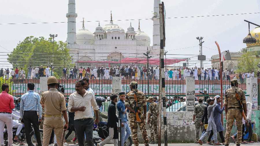 Security personnel stand guard as Muslim devotees stage a protest at Tile Wali Masjid, in Lucknow