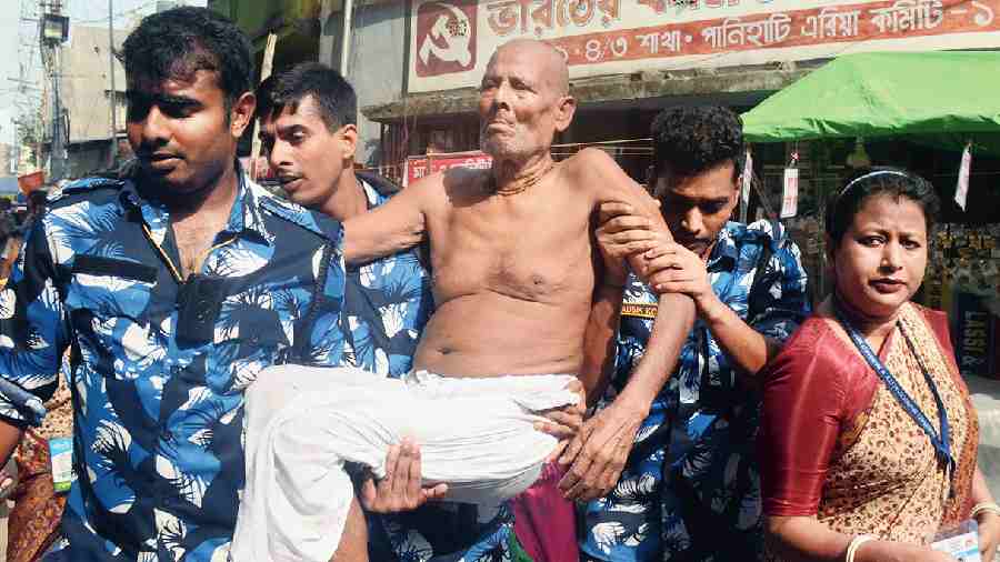 An elderly devotee being evacuated by volunteers from the Iskcon temple at Panihati, North 24-Parganas, on Sunday. 