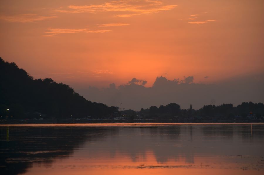Colours of dusk: Sunsets are dramatic on the Dal. With the water reflecting the sky and every contour on the shore, the play of fiery colours and dark shadows are like a painting come alive