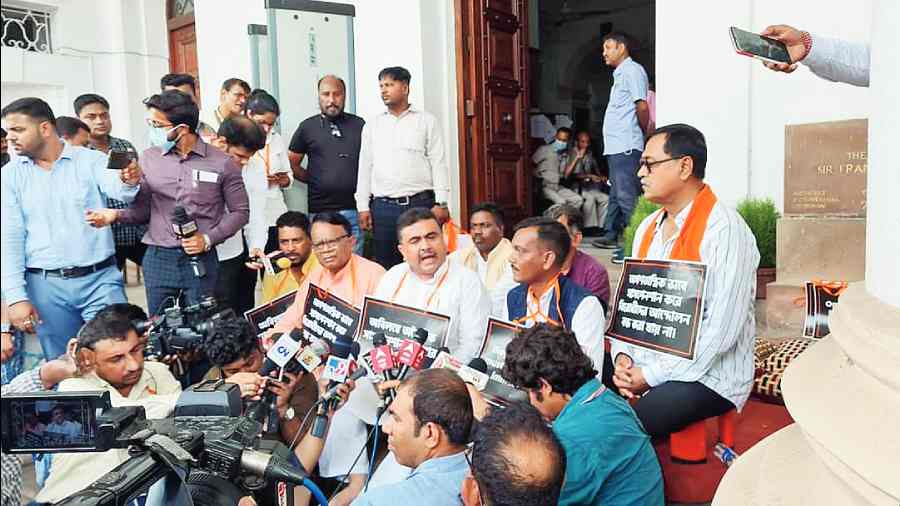 BJP MLAs shout slogans against the state government outside the Assembly on Monday.