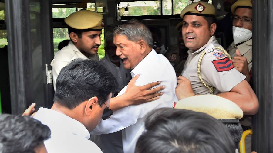 Police detain Congress leader Harish Rawat during a protest march outside the AICC headquarters ahead of Congress leader Rahul Gandhis second appearance before Enforcement Directorate in National Herald case, in New Delhi