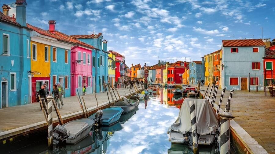 The entire island of Burano is crisscrossed by canals and spectacularly colourful architecture.