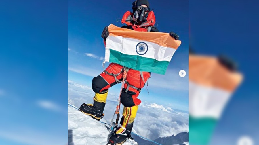 Priyanka Mohite with the Indian flag atop Mt. Kanchenjunga