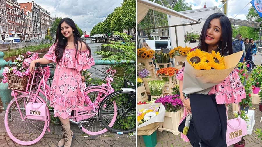 Flower power, pretty pink and a bicycle ride. This fashionista sure knows her travel fashion right. Don’t miss the Versace bag!
