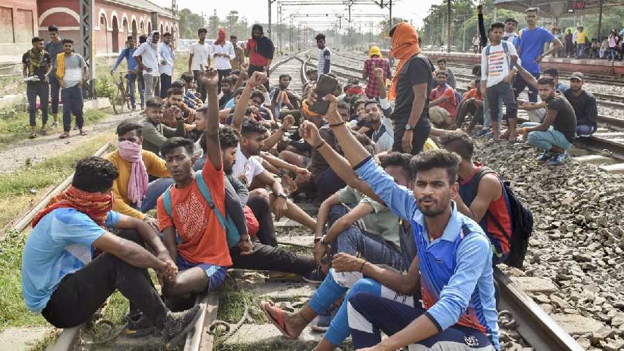 Angry youngsters blocked railway tracks, threw burning tyres on roads and performed push-ups and other drills on the streets